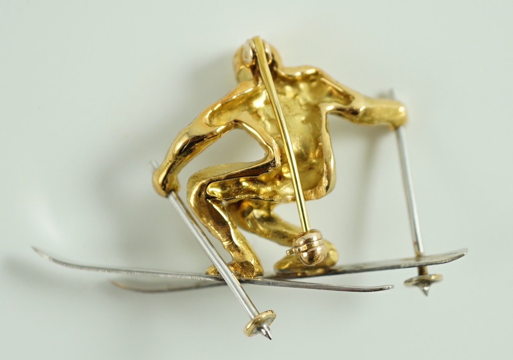 A gold and platinum novelty brooch modelled as a skier